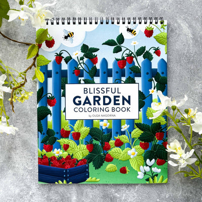 Coloring book titled 'Blissful Garden' with garden-themed cover on a gray background.