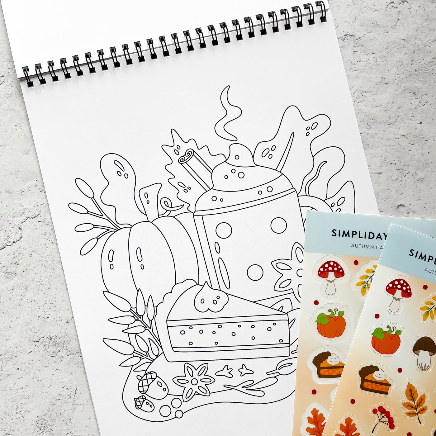 Color your way through autumn, a coloring book filled with pumpkin spice moments and cozy scenes, including fall bookstore and fall bakery.