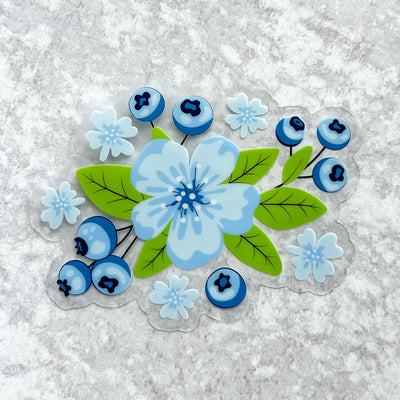 Florals and blueberries clear vinyl sticker by Simpliday Paper by Olga Nagorna comes with a solid white backing, but is clear once the backing is removed.