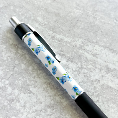 Our beautiful Forget-Me-Not Pen is the perfect companion for your Simpliday Paper notebooks and notepads and a staple for your desk or purse. This premium ballpoint pen features Simpliday Paper artwork that wraps entirely around the pen.&nbsp;