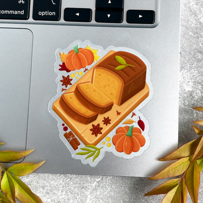 Sticker of a loaf of bread with pumpkins on a laptop keyboard.