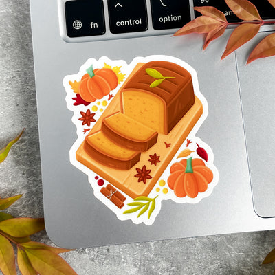 Sticker of a loaf of bread with pumpkins and leaves on a laptop.