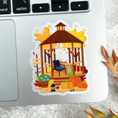 Sticker of a wooden gazebo with pumpkins on a laptop.