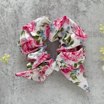 Floral scrunchie on a gray surface.