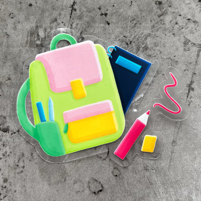 Green and pink backpack vinyl sticker, offered in classic white with white background and white border or clear sticker with a solid white backing, but is clear once the backing is removed. School stickers by Simpliday Paper by Olga Nagorna